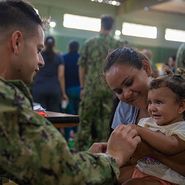 soldier giving child a flu shot. soldier giving child a flu shot.